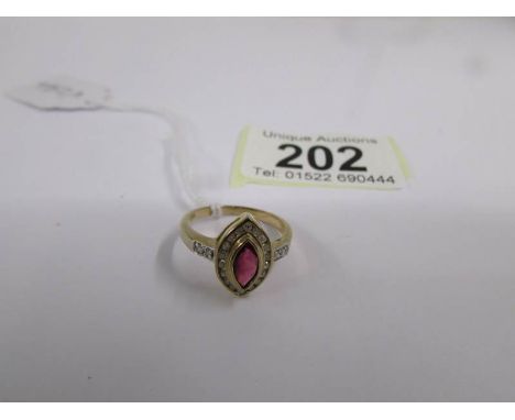 A 9ct gold ring set central ruby and diamonds, size M half.