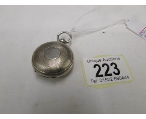 A silver sovereign case dated 1911, made by Dennison of Birmingham, engine turned finish, in good condition.