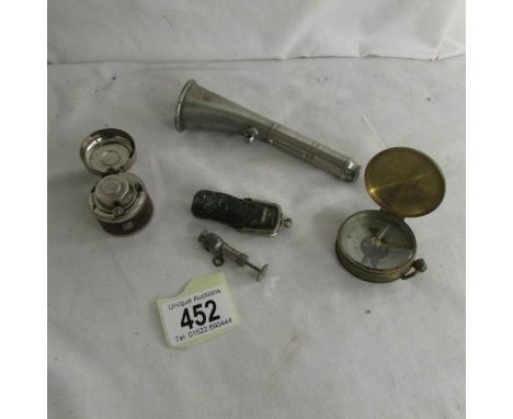 A Victorian travelling inkwell, a cigar piercer, a brass compass and a bosun's horn in working order.