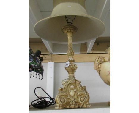 A classical style table lamp with shade.