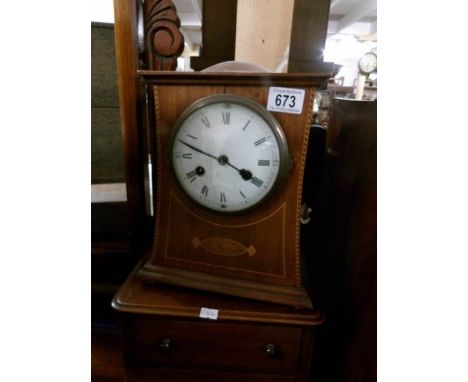 An Edwardian mahogany inlaid mantel clock, in working order and with key.