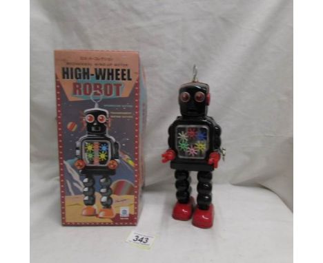 A tinplate clockwork high wheel robot in original box.