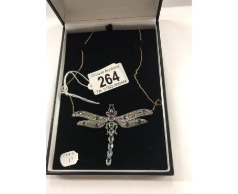 A superb quality dragonfly pendant set sapphires, rubies, aquamarine etc., on an 18ct gold chain.