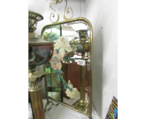 A brass fire screen with floral painted mirror inset.