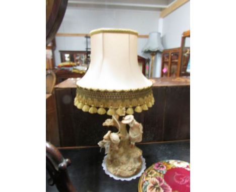 A Royal Worcester table lamp with shade, signed Hadley (has a chip on one leaf otherwise in good condition).