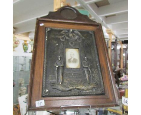 A First World War cast plaster memorial frame with bronzed finish complete with photograph and death / memorial plaque atop f