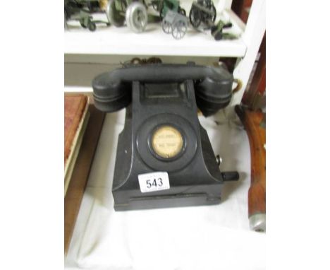 A vintage black telephone.