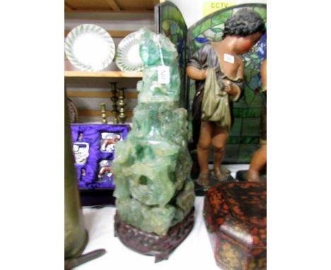 A tall heavy piece of carved jade on original stand, a/f.