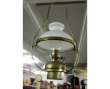 A brass ceiling oil lamp.