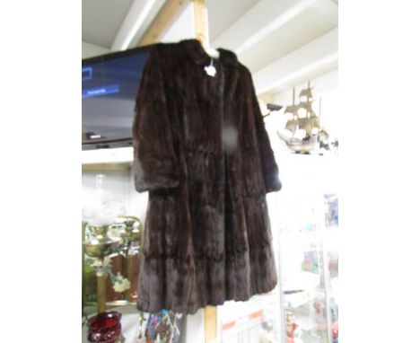 A vintage mink fur coat in a very dark brown / black colour, size 14/16.