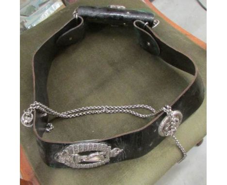 A Royal Ulster Rifles leather belt featuring silver badges, chain and whistle.  Formerly owned by Major Charles Blake, Army N