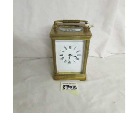 A brass carriage clock complete with key.