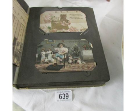 A post card album of in excess of 100 vintage postcards including birthday, Christmas, Dorchester, Hunt House, Titanic and Ol