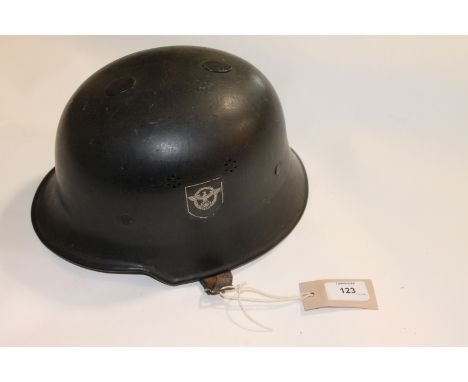 A GERMAN HELMET. A WW11 style German Police Helmet with double decals, in black finish. Tan liner and chinstrap, marked D.R.P
