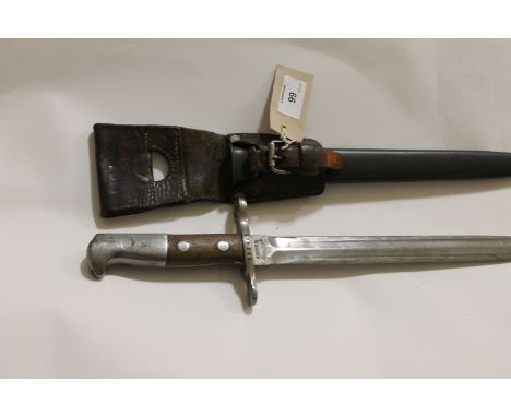 A SWISS BAYONET & SCABBARD. A Swiss K31 model bayonet with double-edged 11.5/8" blaade, complete with steel scabbard and frog