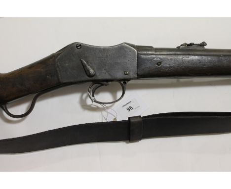 A MARTINI-HENRI CARBINE & A BAYONET. A Matini-Henri carbine with Crown over a faint VR then Enfield, 1885 and 11. The barrel 