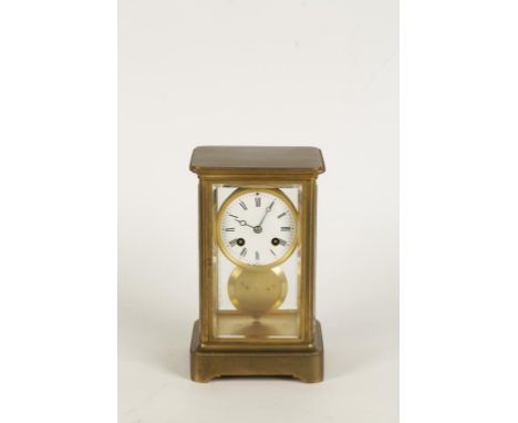 A BRASS "FOUR GLASS" MANTEL CLOCK, the bevelled glass plates enclosing a circular white enamel dial with Roman numerals and t