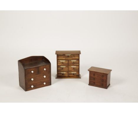A MINIATURE VICTORIAN CHEST OF TWO SHORT AND TWO LONG DRAWERS with raised back and small ceramic knob handles, 19th century, 