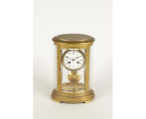 A BRASS "FOUR GLASS" OVAL MANTEL CLOCK, the shaped bevel edged glass panels enclosing a white enamel dial with Roman numerals