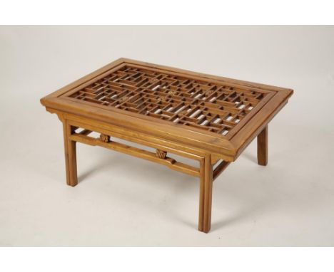 A CHINESE HARDWOOD OCCASIONAL TABLE, the rectangular top with central fretwork panel with carved peach details, above a simil