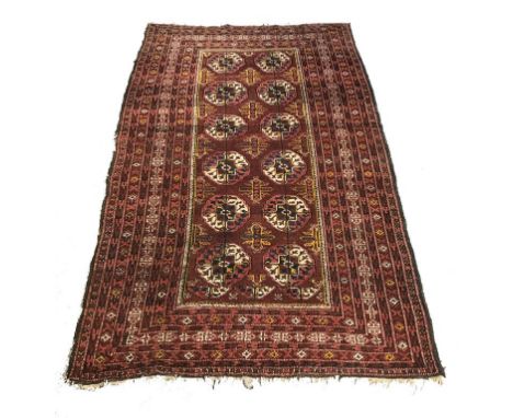 A SMALL BOKHARA TYPE PERSIAN RUG with a central rectangular panel with repeated geometric motifs within a multiguard border, 