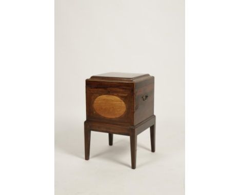 A MAHOGANY CELLARETTE, the square top with raised central panel with fan motifs to each corner, the lid rising to reveal nine