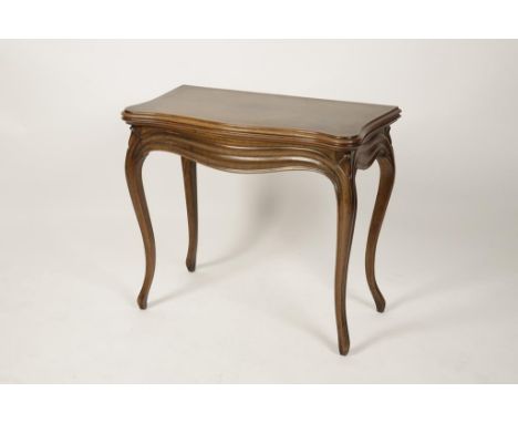 A FRENCH WALNUT CARD TABLE, the serpentine bordered top enclosing a baize-lined playing surface above a serpentine edged frie