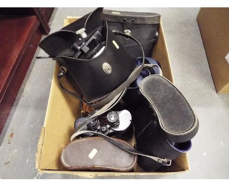 A collection of cased binoculars and vintage cameras