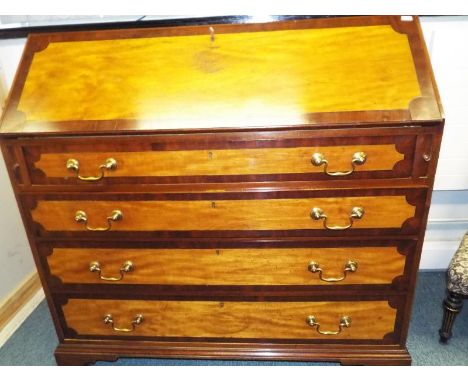A good quality mahogany bureau with adhered plaque marked John Taylor, the slope front opening to reveal a pigeon-hole fitted