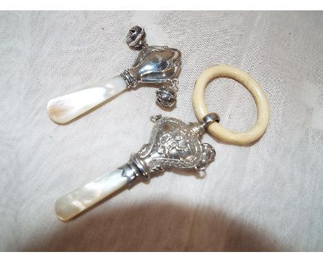 A George V child's silver hallmarked rattle, Birmingham assay 1920 with mother of pearl handle and teething ring and a furthe