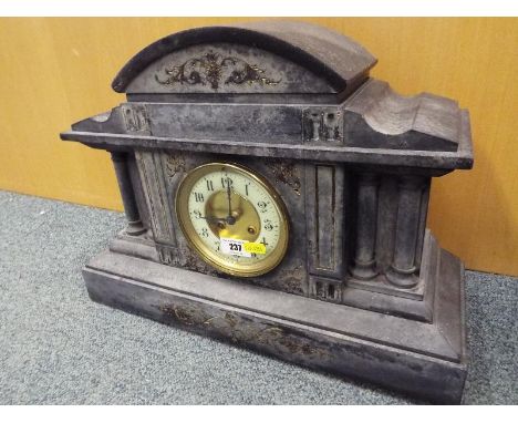 A Belgian black marble cased mantel clock, the case of Classical form flanked by turned columns and having incised, gilt fill