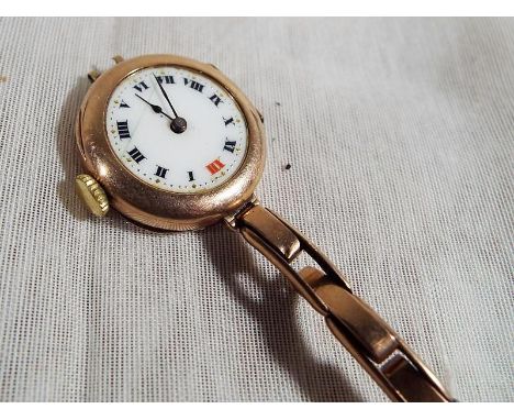 A lady's 9 carat rose gold cased wristwatch, the case marked inside Rolex matching the 15 jewelled Rolex movement, white enam