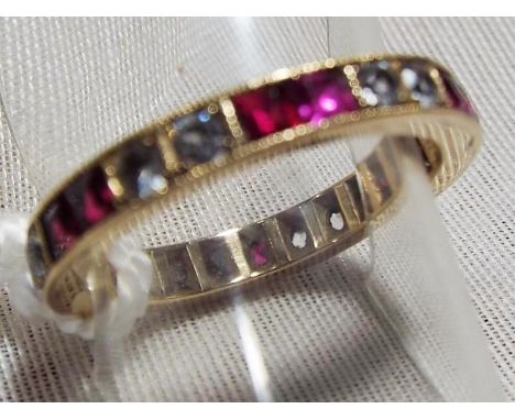A lady's yellow metal full eternity ring, red and white synthetic stones, approximate weight 2.66 gm (all in) size M, Est £20