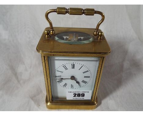 An early 20th century brass cased carriage clock, Roman numerals on a white dial Est £50 - £80
