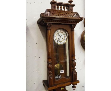 An early 20th century Vienna style wall clock, the case in polished light wood, possibly beech, turned and applied decoration