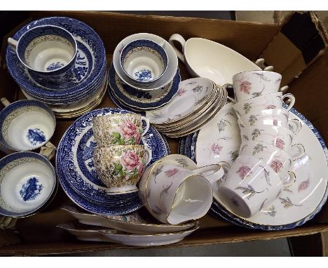 A quantity of ceramic table ware to include Tuscan, Royal Windsor, Booths Real Old Willow and similar 