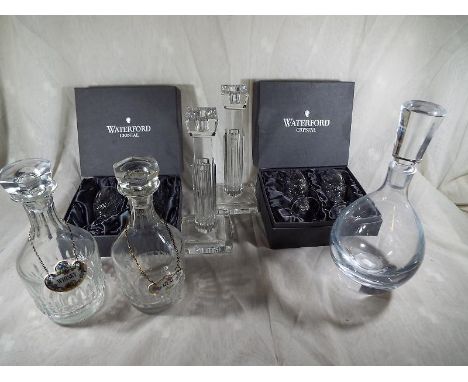 Two boxes of Waterford Crystal wine glasses, two Waterford Crystal Art Deco style candlesticks and three decanters two of whi