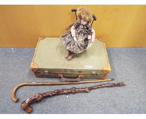 Two walking sticks, a doll and a vintage suitcase (qty)