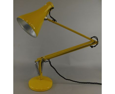 A retro style yellow Anglepoise table lamp