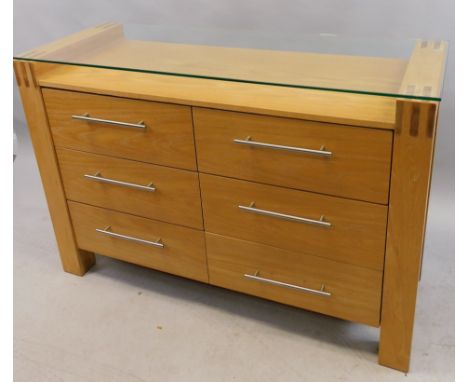 A modern light oak side cabinet, with a glazed stepped top above six drawers, 120cm wide