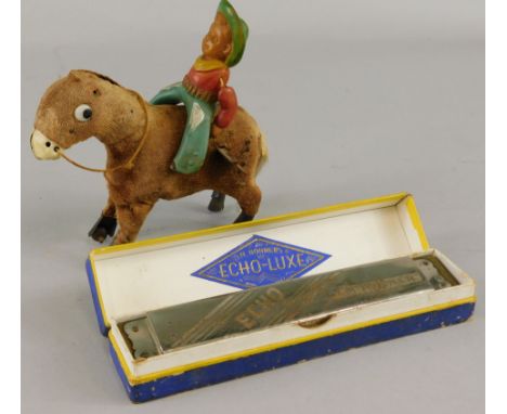 A Japanese clockwork toy cowboy and horse, and an Echo Luxe Hohner mouth organ