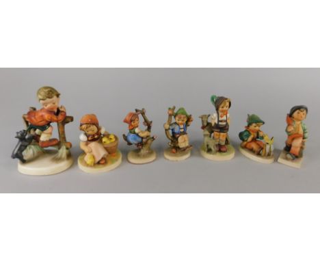 A collection of seven Hummel and Hummel type figures, to include an example stamped Montreal Canada etc.