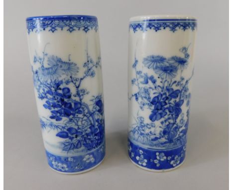A pair of Japanese porcelain cylindrical vases, each decorated with flowering branches etc., 15cm high