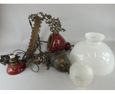 A Continental gilt metal and red ceramic ceiling oil lamp, with small frosted shade and outer opaque glass shade
