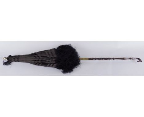 A late Victorian parasol, with turned and carved two section handle and ivory finial