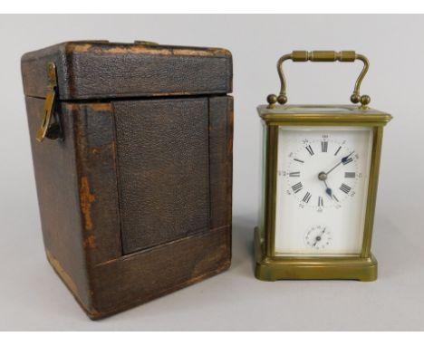 A French brass carriage clock, with white enamel dial and leather travelling case, 14cm high
