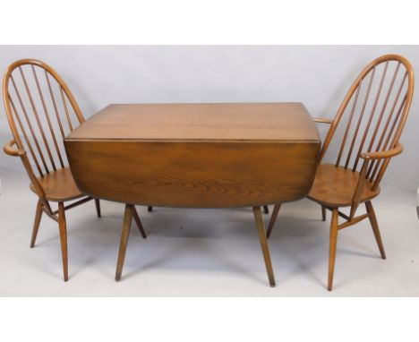 An Ercol elm dropleaf kitchen table, and two open armchairs