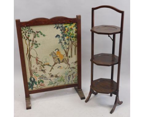 An Edwardian mahogany three division folding cake stand, and a tapestry firescreen