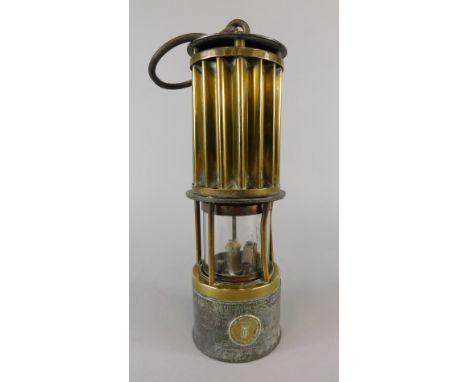 A late 19thC/early 20thC brass and iron miner's lamp, made by the Premier Lamp Company of Leeds, 26cm high