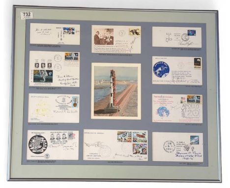 A framed and glazed display of a watercolour depicting a rocket before launch, surrounded by signed copies of first day cover